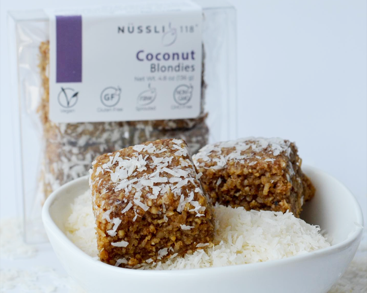 Vegan baked goods made of sprouted nuts and organic superfoods blondie in coconut flakes