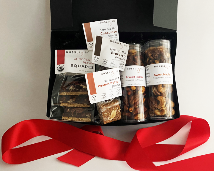 Photo of vegan gift basket filled with vegan chocolate, sprouted nut and sprouted seed vegan protein snacks.