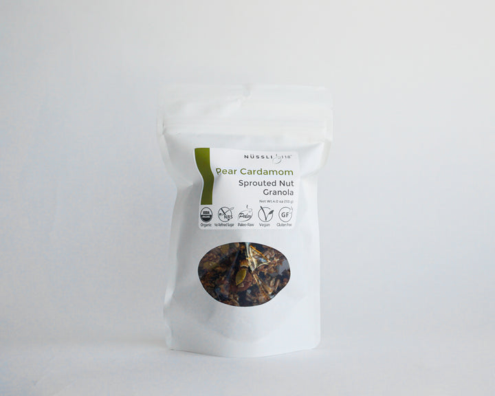 Image of compostable bag containing pear cardamom granola made of sprouted nuts and sprouted seeds by Nussli118.rom 